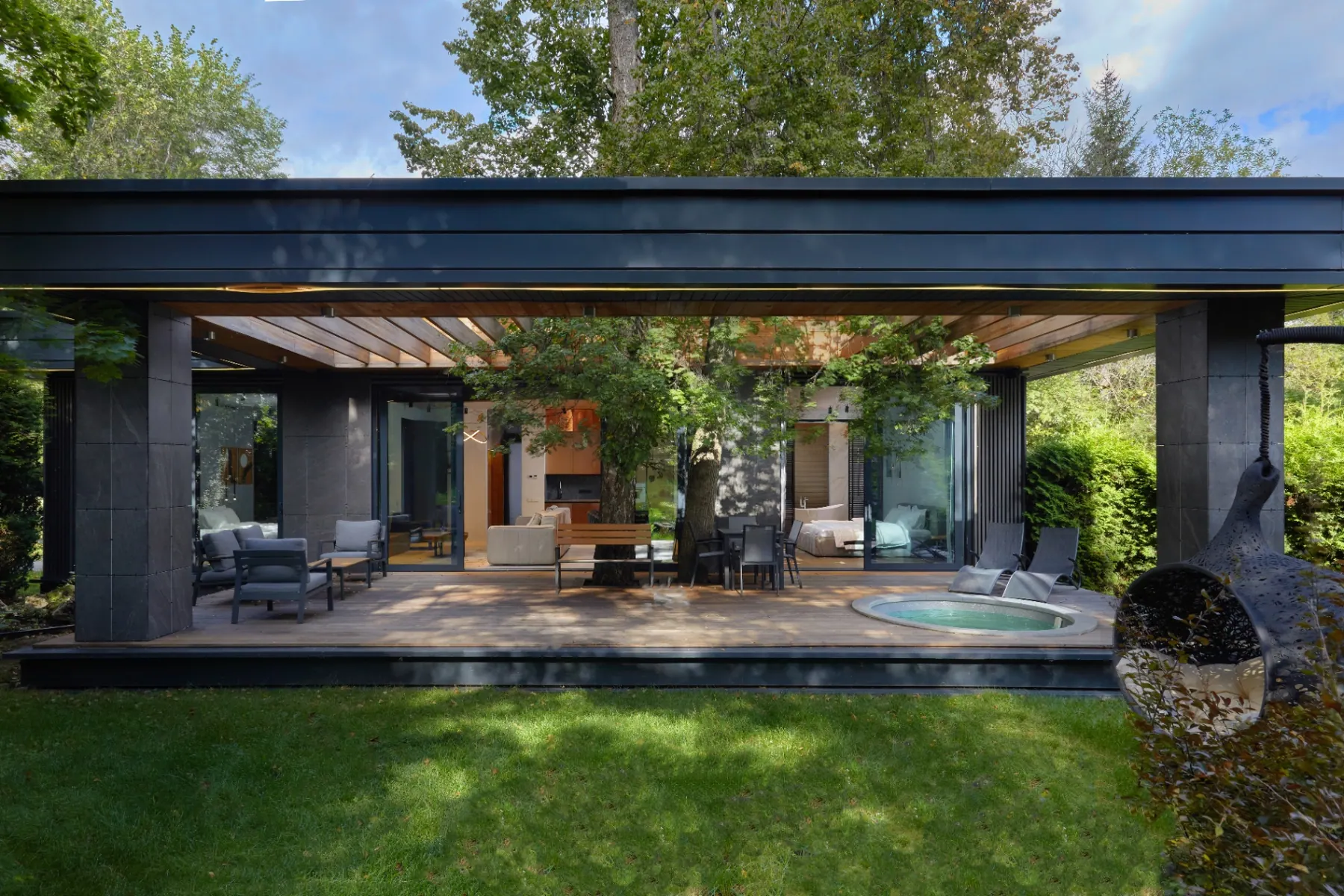 Berta Village villa terrace with outdoor lounge and jacuzzi under the trees