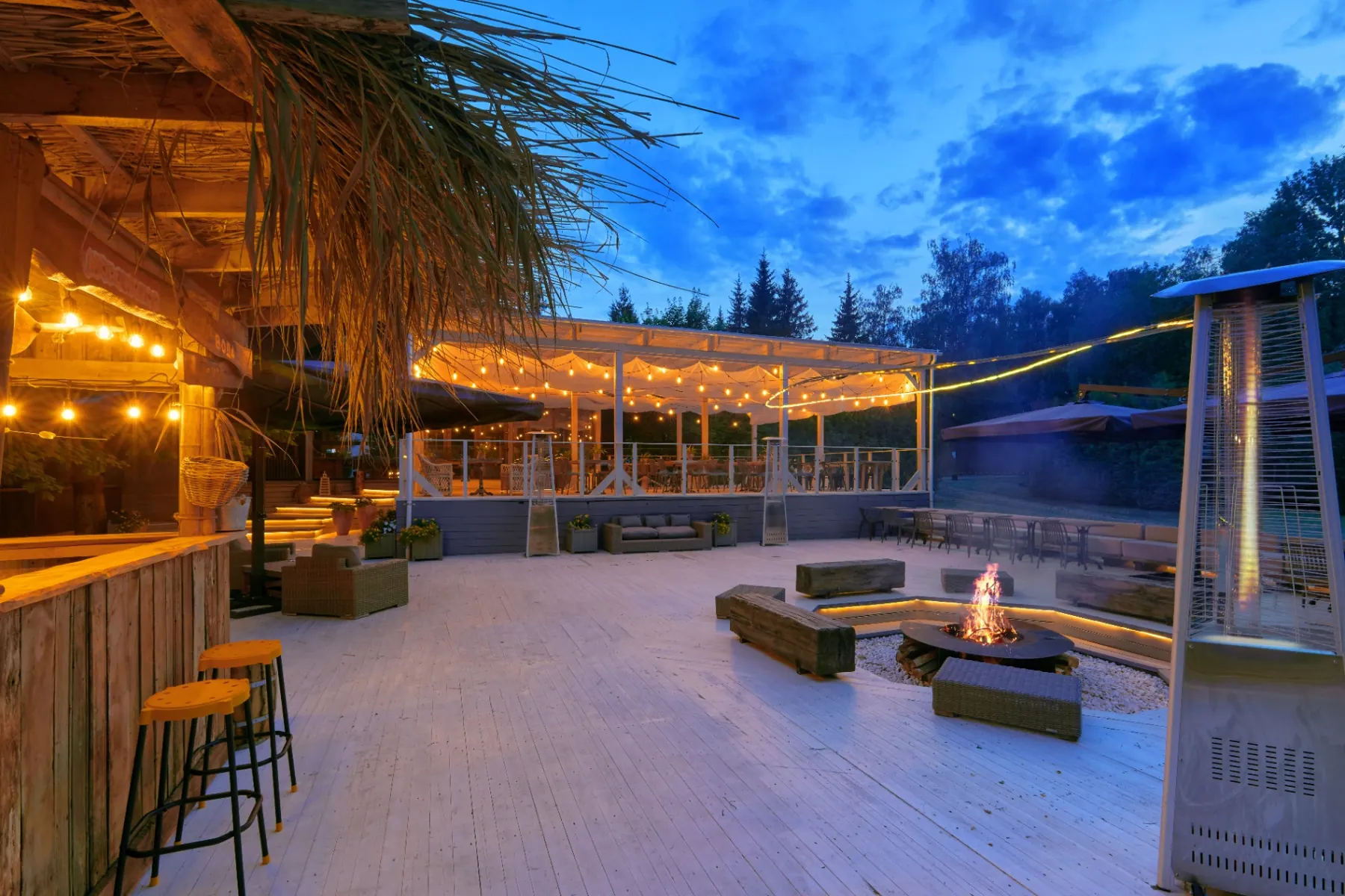 Berta Village terrace at dusk with firepit and string lights